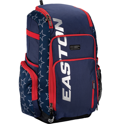 The Easton Roadhouse Backpack (EBA004) by Easton features navy blue and red colors, white star patterns, "EASTON" in silver on the front pocket, plus multiple compartments and side pockets for baseball or softball gear.