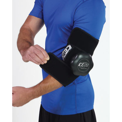 A person wears a blue shirt while securing the Bownet ICE20 Elbow / Small Knee Ice Compression Wrap (ICE-ELBOW-SM KNEE) with attached ice pack around their right elbow for targeted cold therapy.