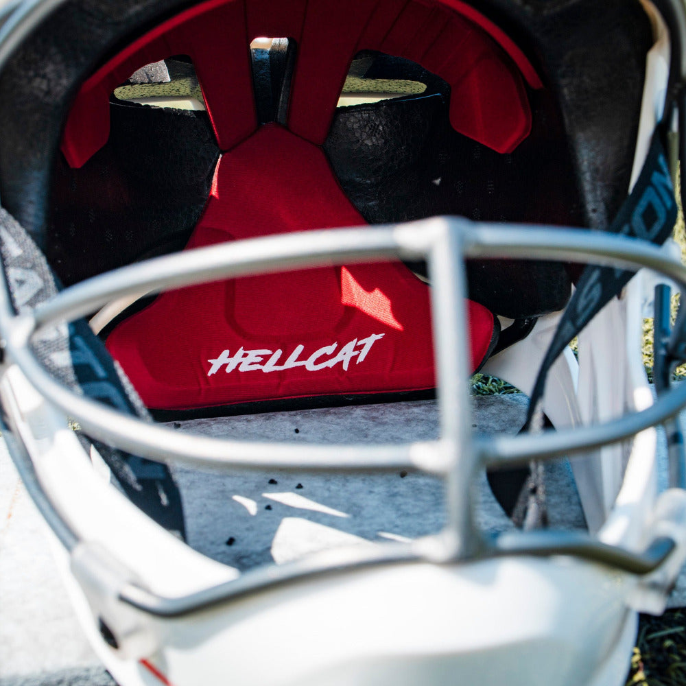 Close-up of the Easton Hellcat Slowpitch Fielding Helmet (EHCATH) by Easton, highlighting its red padding and bold white HELLCAT lettering inside this premium protective helmet.