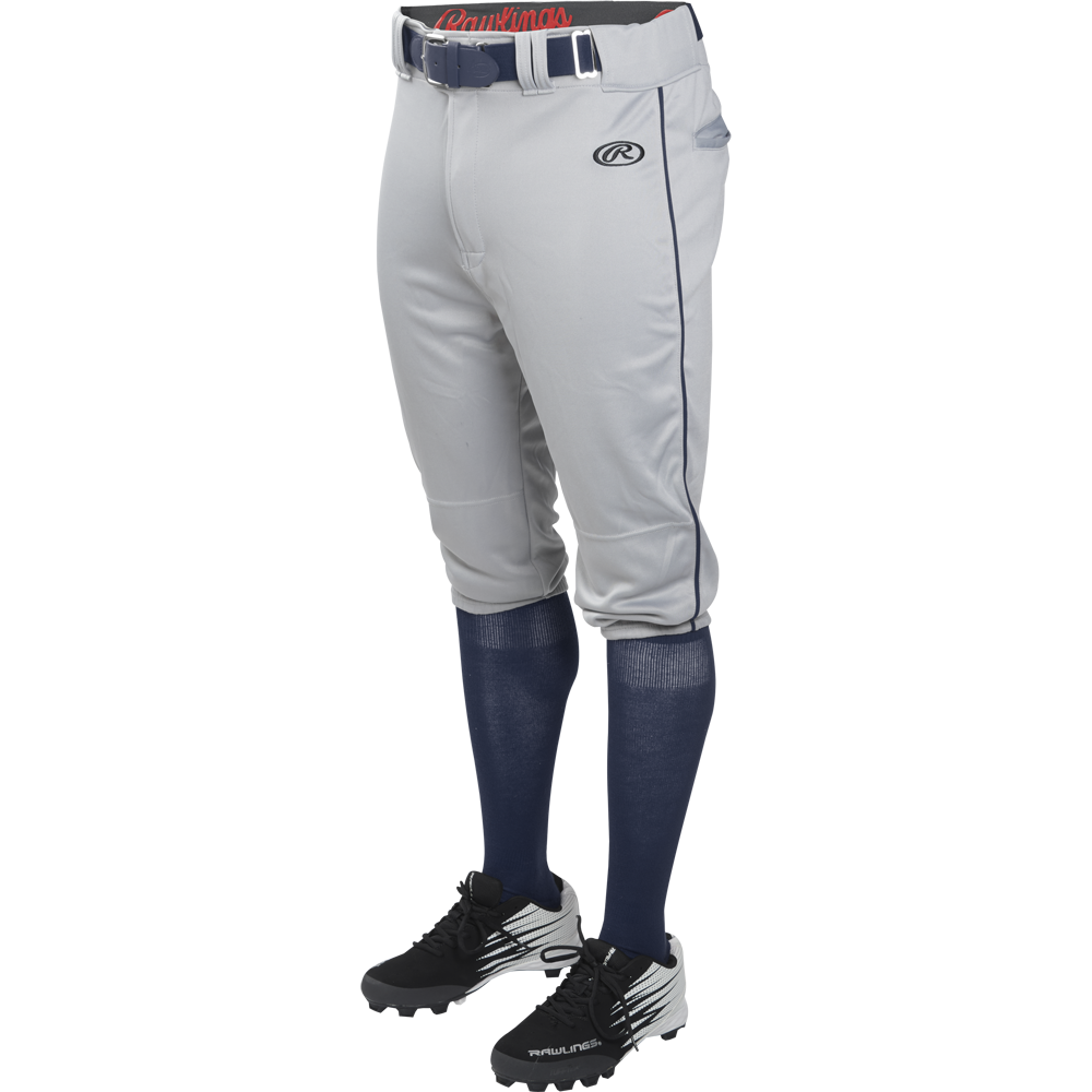 A person wears Rawlings Adult Launch Knicker Baseball Pants with Piping (Blue Grey/Navy), styled with a blue belt, blue knee-high socks, and black and white cleats, shown waist down against a plain background.