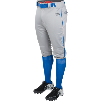 Someone wearing Rawlings Adult Launch Knicker Baseball Pants (Blue Grey/Royal) with blue piping, paired with a blue belt, blue high socks, and black and white cleats. The upper body is not visible.