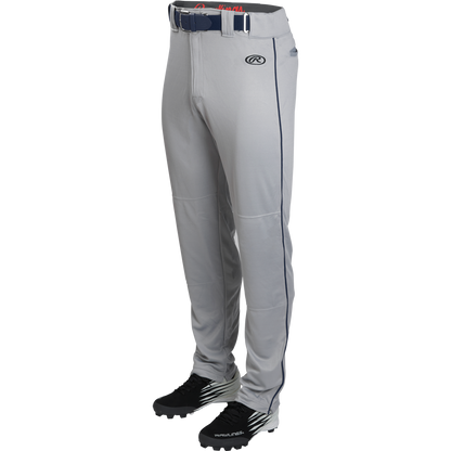 A pair of Rawlings Youth Launch Semi-Relaxed Baseball Pants with navy piping and waistband, shown with black cleats on a white background.
