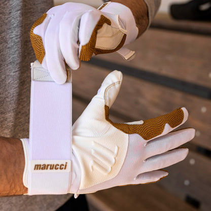 A person wearing Marucci Blacksmith Adult Batting Gloves (MBGBKSMFW) featuring a durable training glove design and goatskin palm.