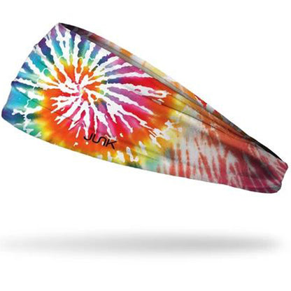 The Junk Moksha Headband by Junk features a vibrant rainbow tie-dye design, is made from sweat-wicking technical t-shirt fabric, stretches for comfort, and displays the bold black JUNK logo on one side.