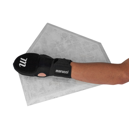 A person wearing a Marucci Sliding Mitt: MPSLDMITT rests their hand on a home plate, with only the arm visible against a white background.