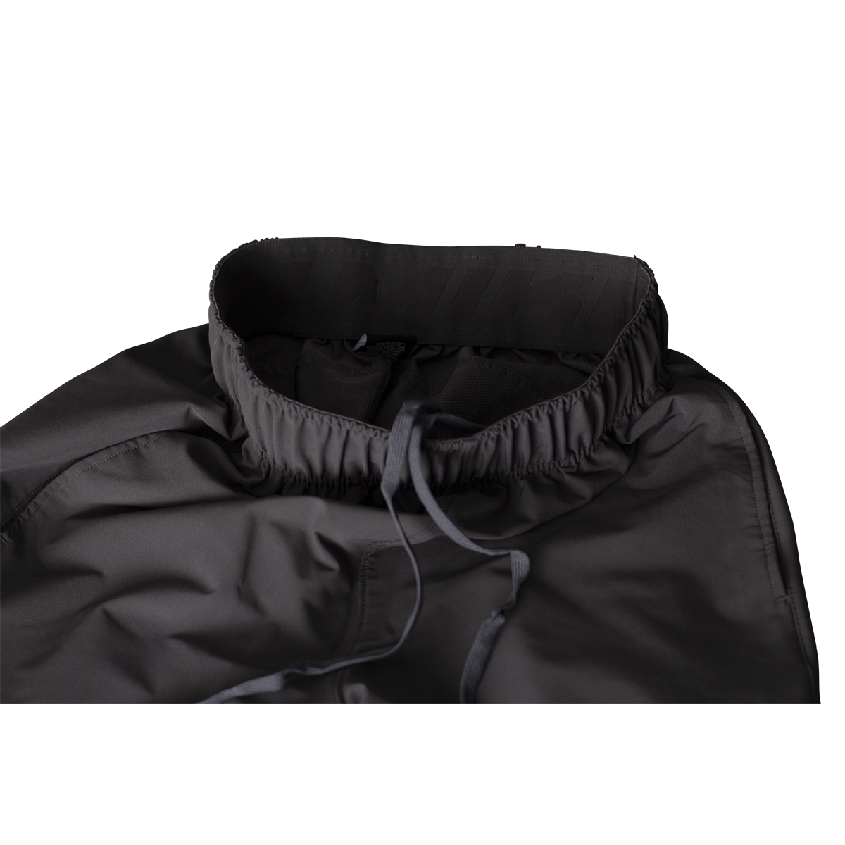 Close-up of Miken Men's Slowpitch Shorts (MSPSM20) by Miken, paired with a dark gray, high-collared jacket featuring an elastic drawstring at the neck, displayed on a plain white background.