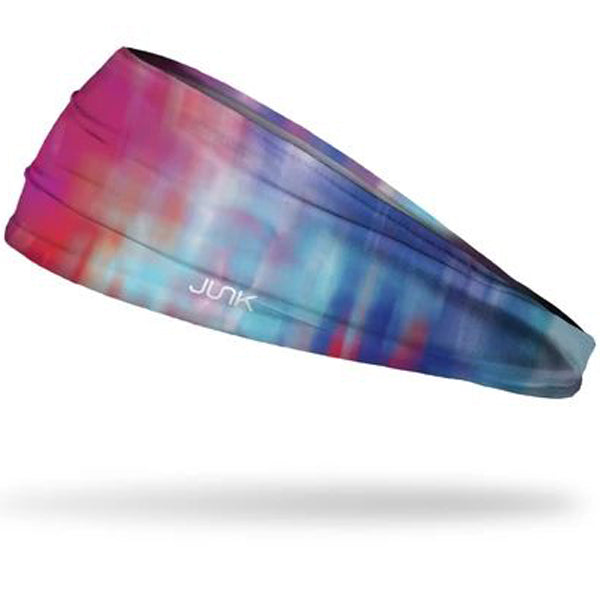 The Junk Northern Lights Headband by Junk features a vibrant pink, red, blue, and purple gradient design, made from moisture-wicking technical t-shirt fabric with the white JUNK logo on the side.