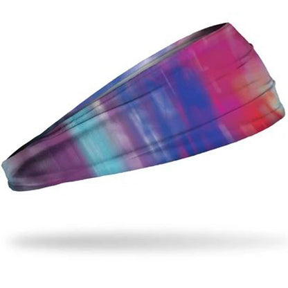 The Junk Northern Lights Headband by Junk is a wide, stretchy athletic headband with a vibrant pink, blue, purple, and turquoise abstract pattern, made from moisture-wicking technical T-shirt fabric and shown on a white background.