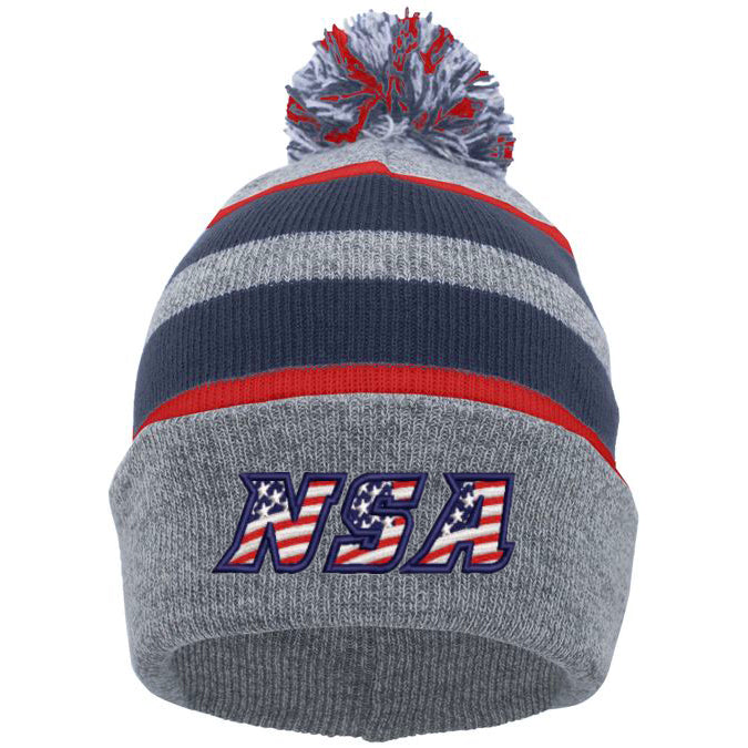 The Pacific Headwear NSA Flag Series Beanie (641K-HENVRD) features gray and navy colors, red stripes, a pom-pom, and the NSA stars and stripes American flag print on the front cuff.