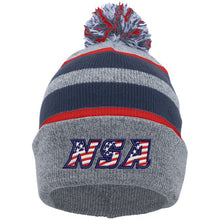 The Pacific Headwear NSA Flag Series Beanie (641K-HENVRD) features gray and navy colors, red stripes, a pom-pom, and the NSA stars and stripes American flag print on the front cuff.