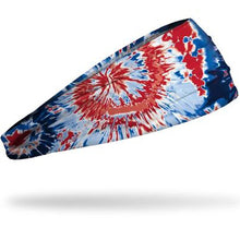 The Junk Pride Headband by Junk features a red, white, and blue tie-dye pattern on sweat-wicking technical t-shirt fabric and is shown on a white background.