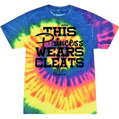 The DSG Apparel NSA This Princess Wears Cleats Short Sleeve Shirt features a vibrant blue, pink, yellow, and orange tie-dye design with bold black text, crown graphic above "Princess," and National Softball Association (NSA) below.