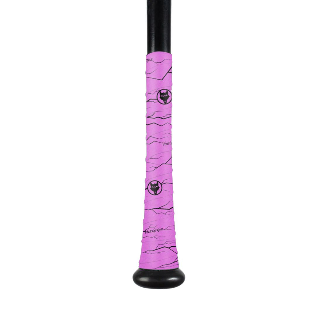 A black baseball bat handle wrapped in VukGripz Bat Grip Tape by VukGripz, featuring bright pink tape with black line designs and a bull head logo. The wrap covers the lower handle, providing optimum grip for confident swings.