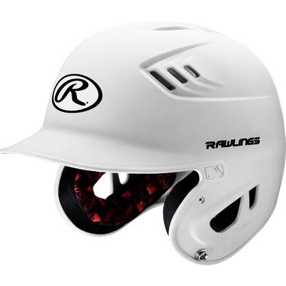 The Rawlings Velo Matte Batting Helmet: R16M features a white design with black logo, protective ear coverage, ventilation holes, and a red padded interior for safety and style in youth baseball.