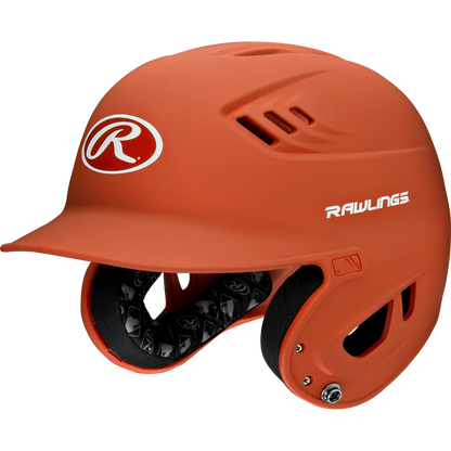 The Rawlings Velo Matte Batting Helmet: R16M features an orange matte finish, protective ear guards, ventilation holes, a white Rawlings logo on the front and side, and black interior padding for comfort and safety—ideal for youth baseball.
