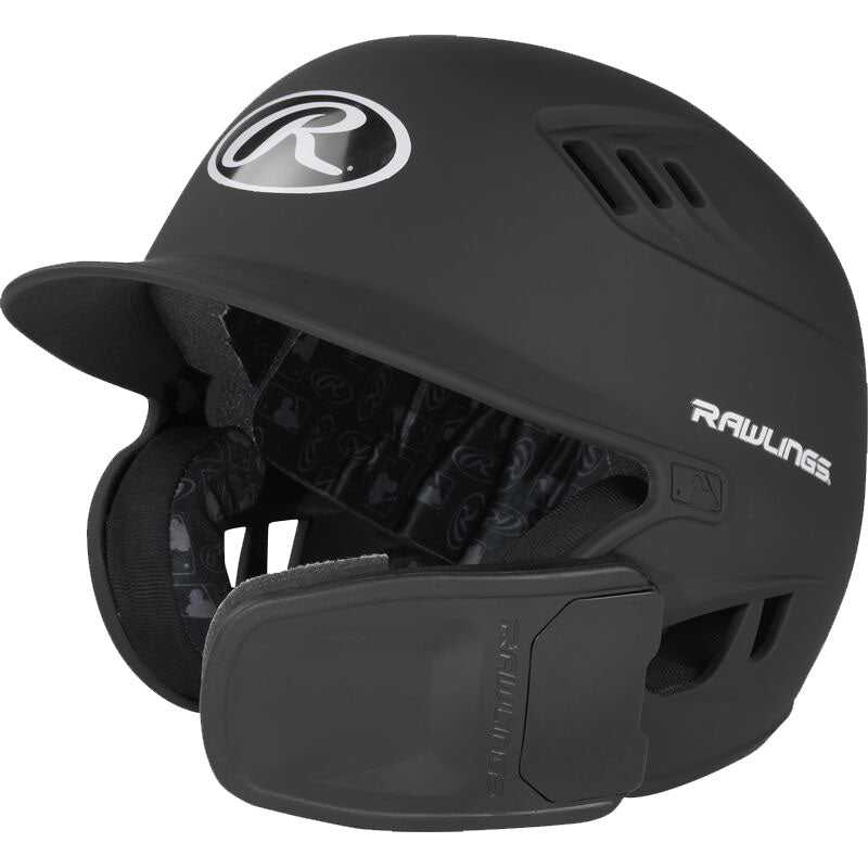 The Rawlings R16 Matte Batting Helmet with Universal Jaw Guard (R6R07) features ear and jaw protection, a matte black finish, ventilation holes, front Rawlings logo, and padded interior lining.