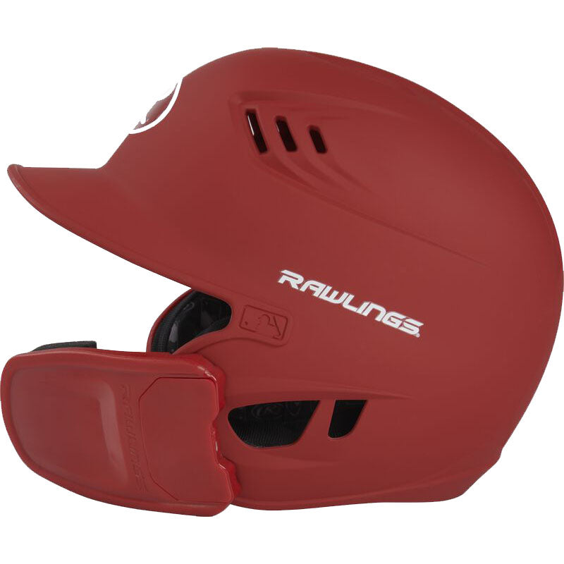 The Rawlings R16 Matte Batting Helmet with Universal Jaw Guard (R6R07) is a red helmet featuring ventilation holes, the Rawlings logo, MLB logo on the side, and includes a protective jaw guard extension for added safety.
