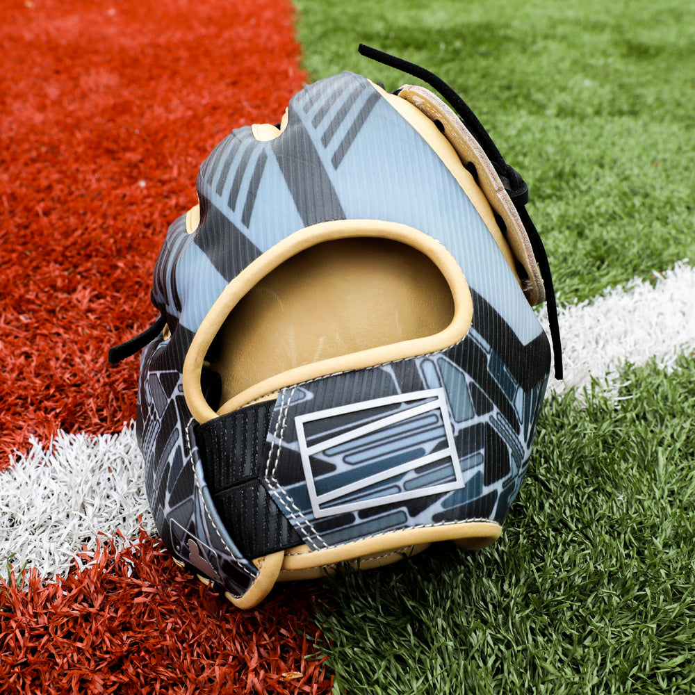 A Rawlings REV1X 12.75" Baseball Glove (REV3039-6) sits on artificial turf, placed between red and green zones with a white line underneath.