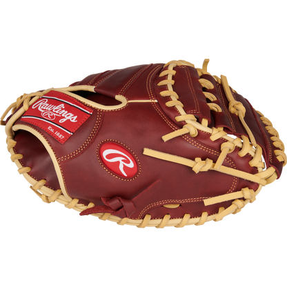A Rawlings Sandlot 33" Baseball Catcher's Mitt (SCM33SS) by Rawlings, featuring brown oiled leather, tan laces, a red logo patch, and white stitching, is shown from the side on a plain white background.
