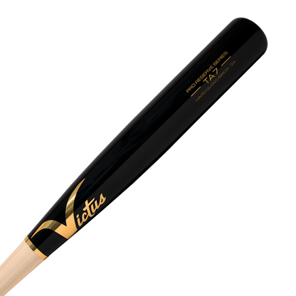 A close-up of the Victus TA7 Tim Anderson Pro Reserve Birch Wood Bat (VRWBTA7-NT/BK) in black and natural wood, featuring gold Victus branding and model details on the barrel, showcases its Big League-grade quality.