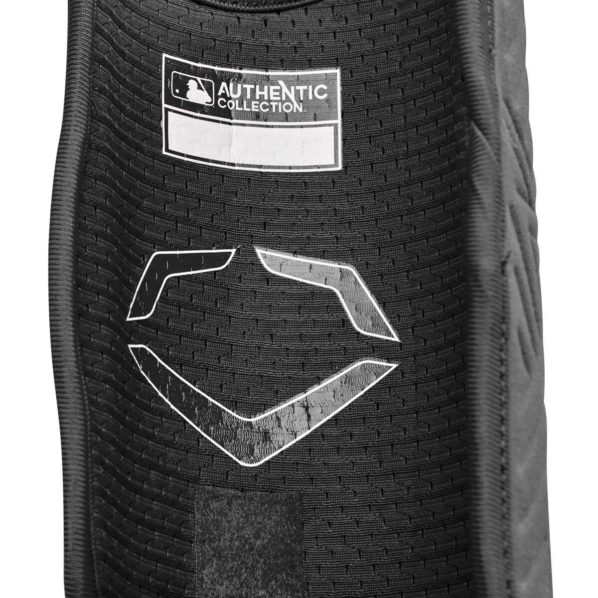 Close-up of a black EvoShield PRO-SRZ 2.0 Batter's Leg Guard (WB5726901) with an MLB Authentic Collection label and white geometric logo, highlighting its textured fabric.