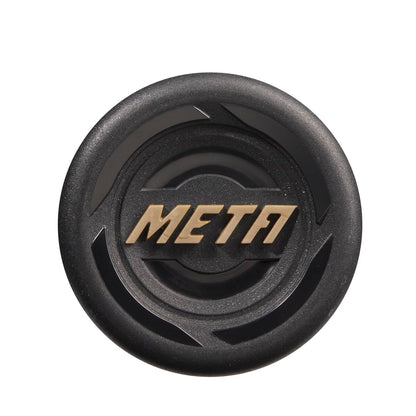 A round, black object with raised gold META letters at the center, resembling the 2023 Louisville Slugger Meta (-5) 2 5/8" USSSA Baseball Bat (WBL2649010), viewed from above against a white background.
