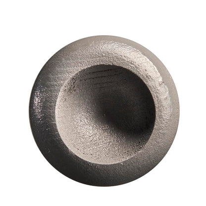 A round, metallic object with a rough, concave center resembling the end cap of the Louisville Slugger Youth Flylite Y243 Wood Baseball Bat: WBL2704010, is displayed against a white background.