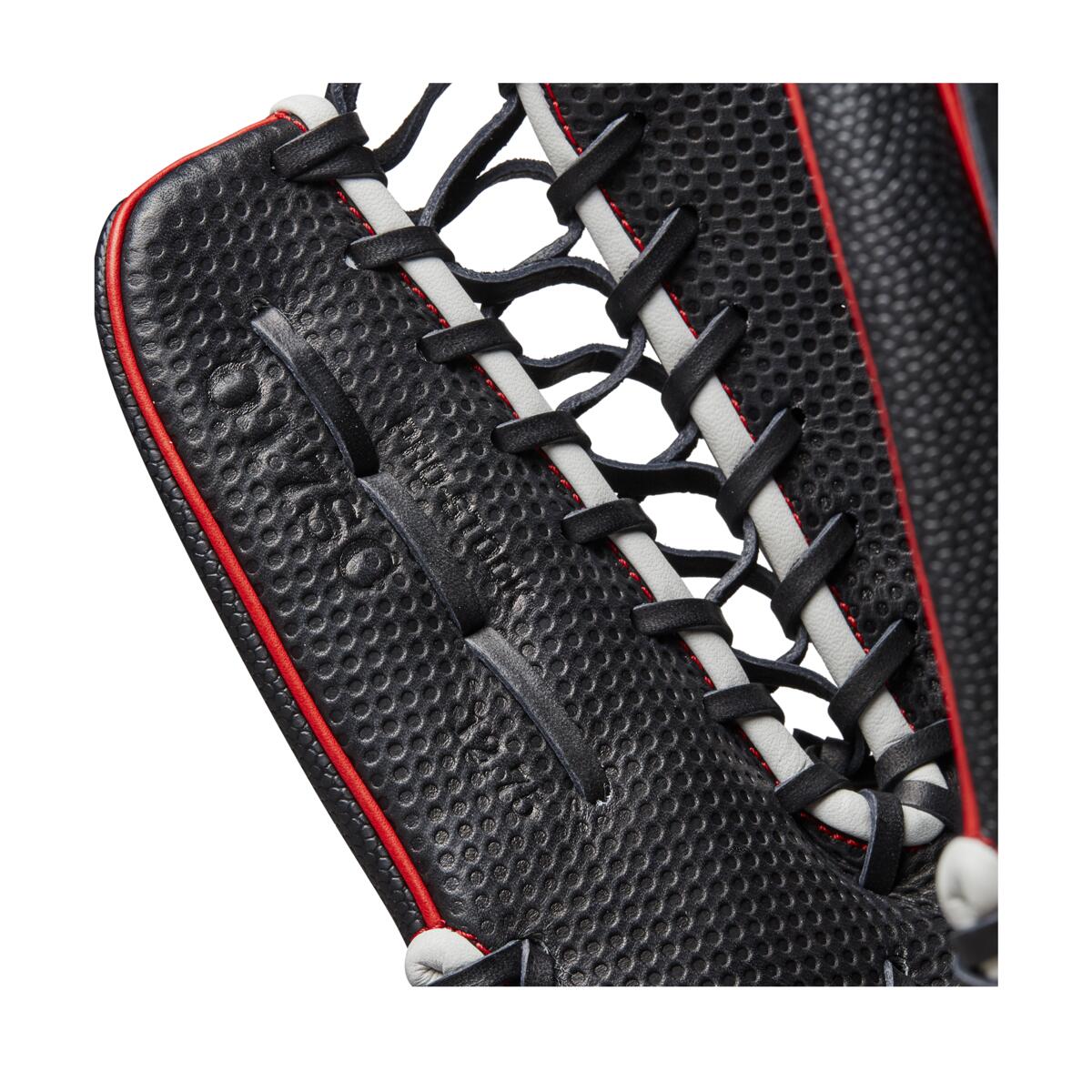 Close-up of the Wilson A2000 OT7SS 12.75" SuperSkin Baseball Glove (WBW1009871275), a black outfield glove with red and white laces, detailed stitching, webbing, and innovative SuperSkin material by Wilson.