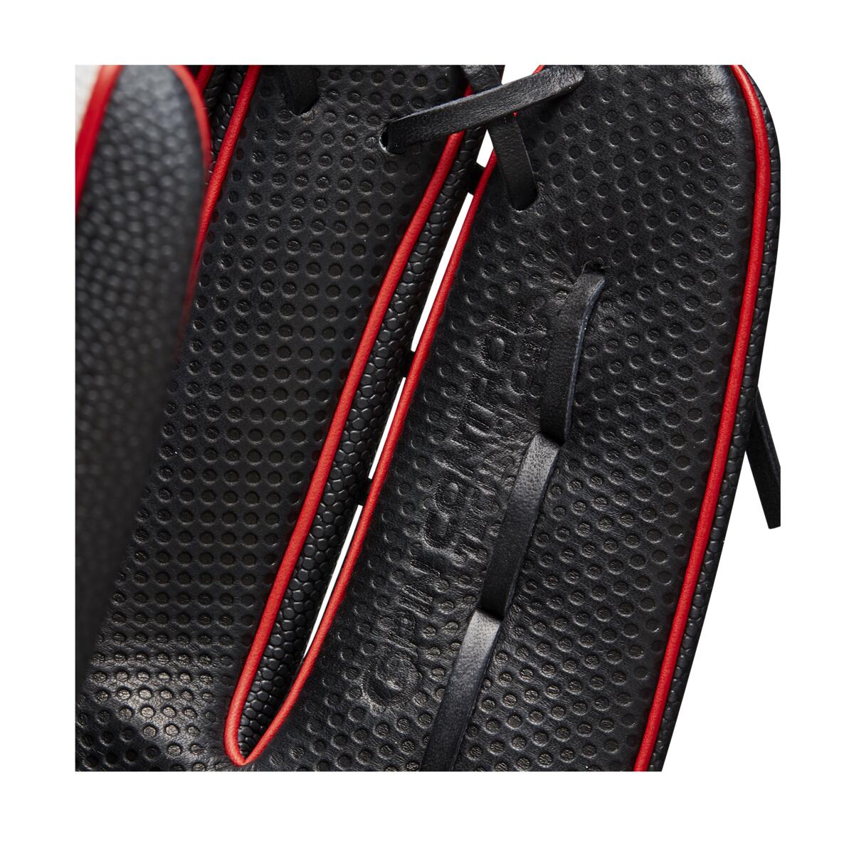 Close-up of the Wilson A2000 OT7SS 12.75" SuperSkin Baseball Glove (WBW1009871275) in black with red trim, black laces, detailed stitching, SuperSkin material, and Spin Control Technology.
