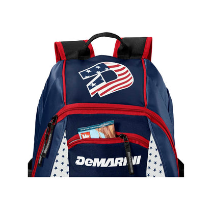 The DeMarini Voodoo Junior Backpack (WTD9106) features a blue and red design with a large American flag D logo and an open front pocket showing Big League Chew gum—ideal as a youth baseball backpack.