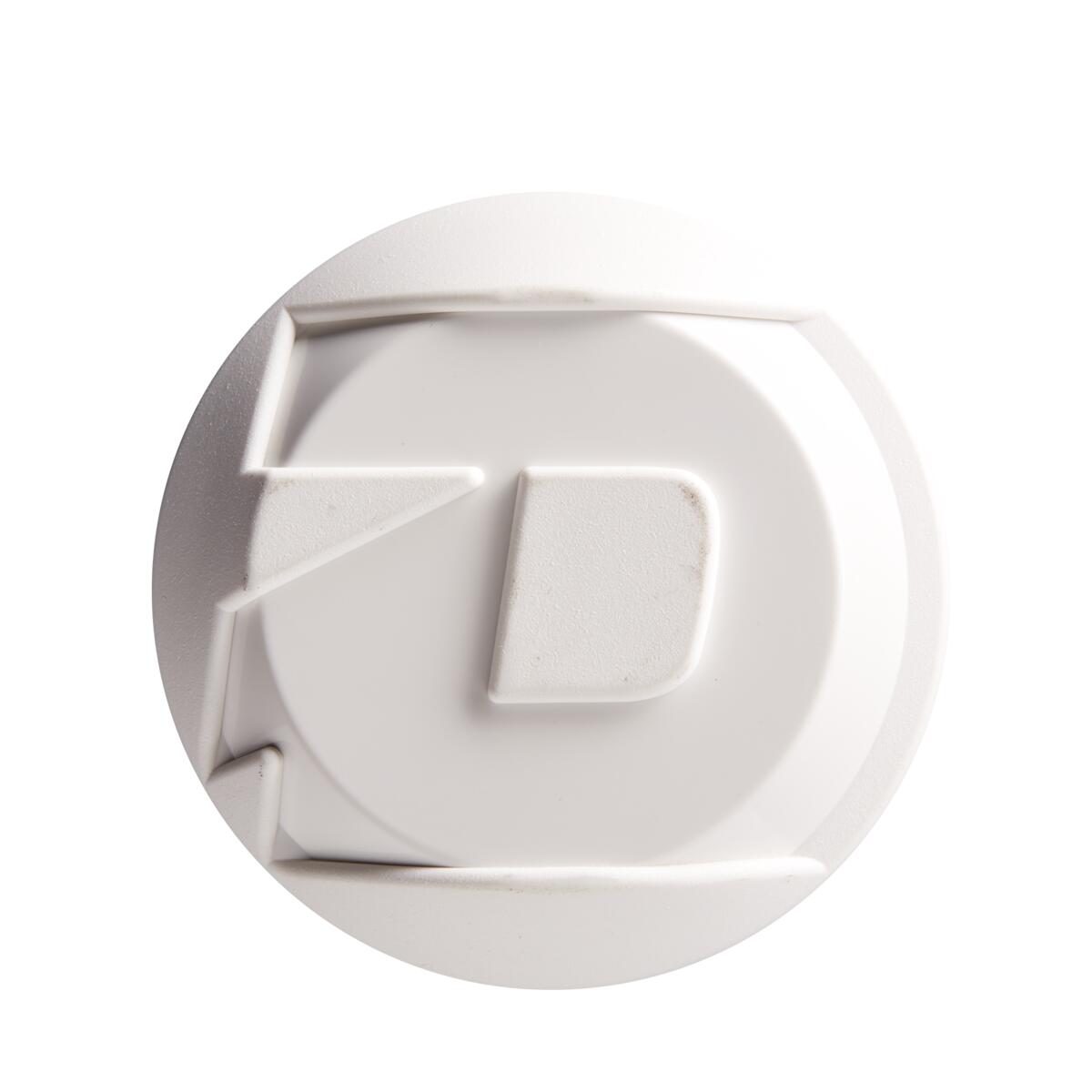 A white, round plastic object with raised geometric shapes and lines, resembling the texture of the DeMarini 2022 Chris Larsen Nautalai 12" Endload NSA/USSSA Slowpitch Softball Bat (WTDXCLU-22), viewed from above on a white background.