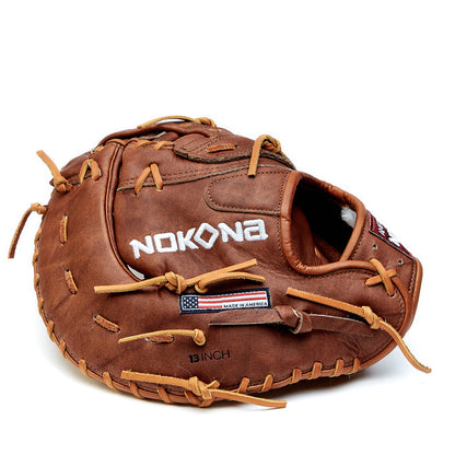 The Nokona Walnut Classic 13" First Base Mitt: W-N70 features brown Walnut Crunch leather, tan laces, NOKONA stitched in white, an American flag "Made in America" patch, and highlights Nokona's tradition of handcrafted quality gloves.