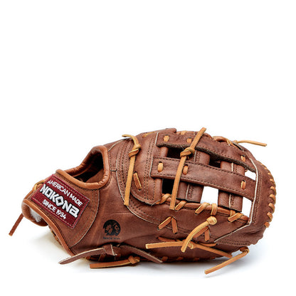 The Nokona Walnut Classic 13" First Base Mitt (W-N70), crafted from brown Walnut Crunch leather with tan laces and a woven web, rests against a white background—showcasing Nokona’s renowned handcrafted quality.