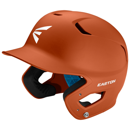 An Easton Z5 2.0 Grip Matte Solid Batting Helmet (Z52MT) in orange with a white Easton logo, protective ear guard, blue interior lining, and NOCSAE certification is displayed on a plain white background.