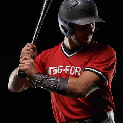 A man holds a baseball bat while wearing the G-Form Pro Wrist Guard (WG0102) by G-Form for added impact protection.