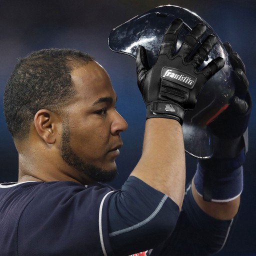 A baseball player in a navy jersey and black Franklin CFX Pro Full Color Chrome Adult Batting Gloves: 205 holds up a black helmet with both hands, partially covering his face.