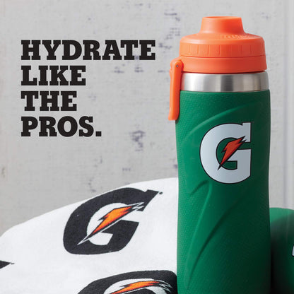 A green Gatorade 26 oz Stainless Steel Water Bottle (43669) with an orange lid stands beside a white towel with the Gatorade logo. Text on the left reads, HYDRATE LIKE THE PROS.