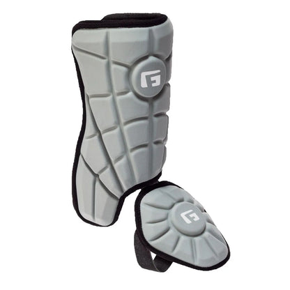 The G-Form Batter's Leg Guard LG0102 is a gray shin guard with SmartFlex padding, black trim, segmented design, attached ankle protector, and features white stylized G logos on both shin and ankle sections for added style.