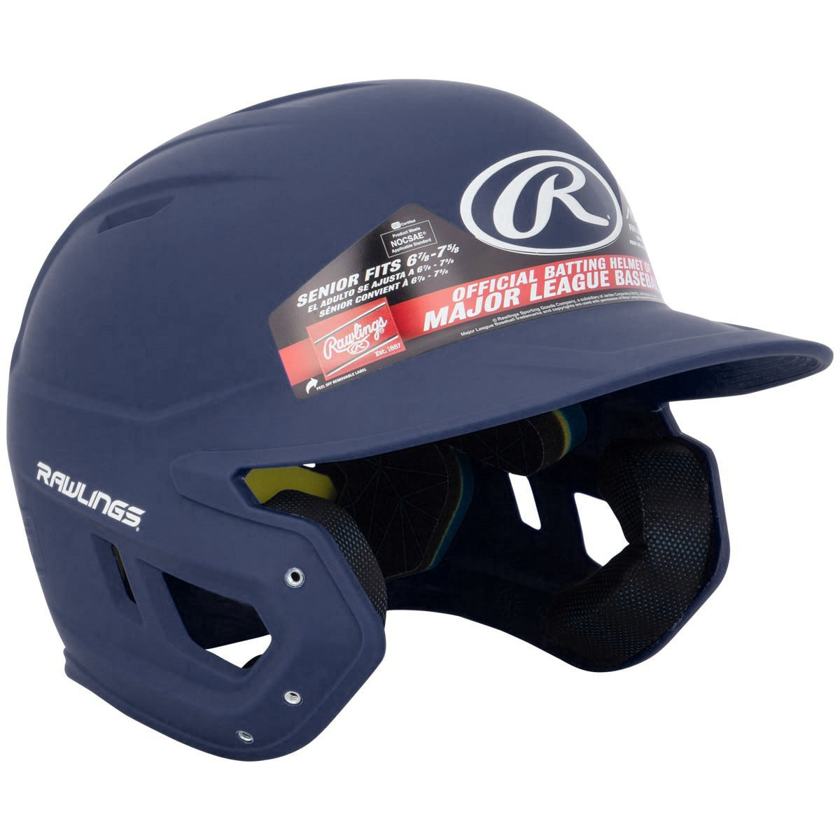 A Rawlings Mach Matte Batting Helmet (MACH) in navy blue with a protective faceguard and sticker labels, designed for senior players, is displayed against a white background.