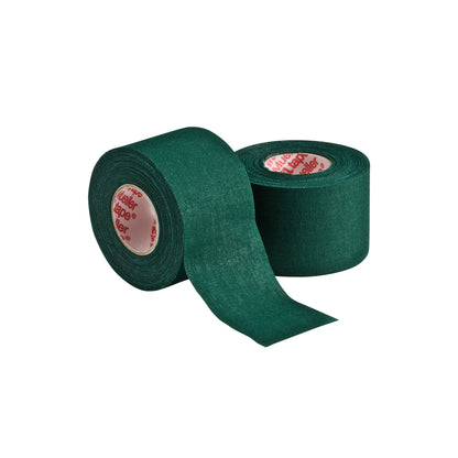 Two rolls of Mueller M Tape Athletic Tape (MTAPE) by Mueller, with durable cotton backcloth in dark green—one upright, one unrolled—displayed on white background; a versatile choice for sports medicine and injury prevention.