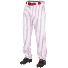 A person wears Rawlings Youth Premium Pinstripe Baseball Pants (YPIN150) in white with red pinstripes, a matching red belt, and black cleats, shown from the waist down. These pants feature 2-way stretch polyester for comfort and performance.