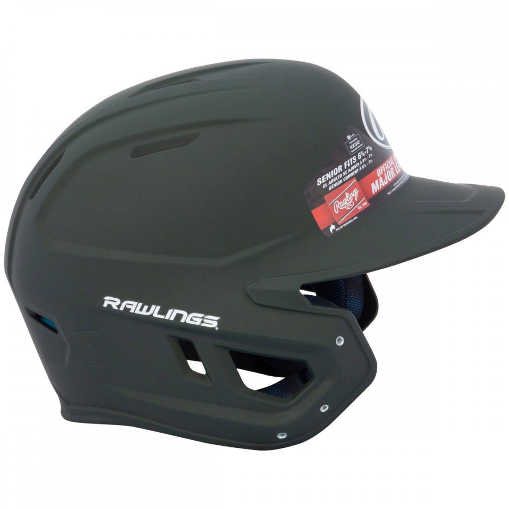 The Rawlings Mach Matte Batting Helmet: MACH features a matte black finish, protective face guard, ventilation holes, and side branding. A product info sticker on the front highlights its quality among baseball helmets.