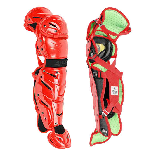 Two All Star System7 Axis Catcher's Leg Guards are shown—one displays the front with padding, knee caps, and LINQ hinge system; the other reveals the interior with straps and green cushioning.
