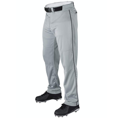 A person wearing Wilson Youth P200 Classic Knit Relaxed Fit Baseball Pants with black piping, a black belt, and black cleats. These Wilson pants have an elastic waistband and relaxed fit, shown against a plain white background.